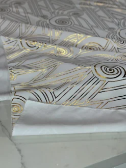 Luxor (Metallic Print) Table Linen in White and Gold